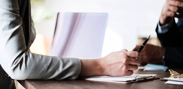 photo of person writing in notebook.